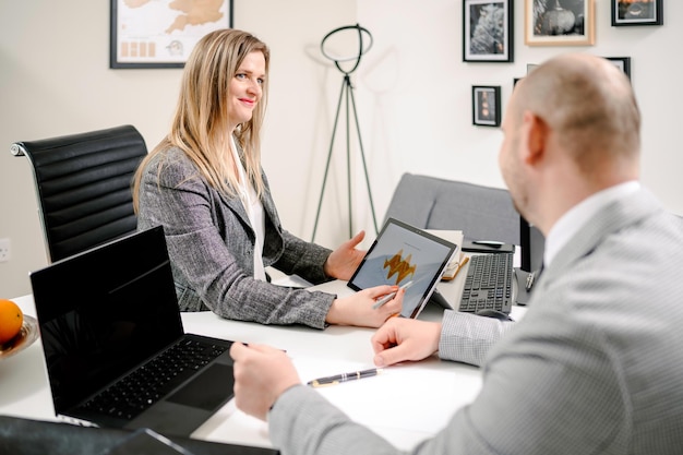 Discussion of Caucasian coworkers while having a business meeting in a modern office