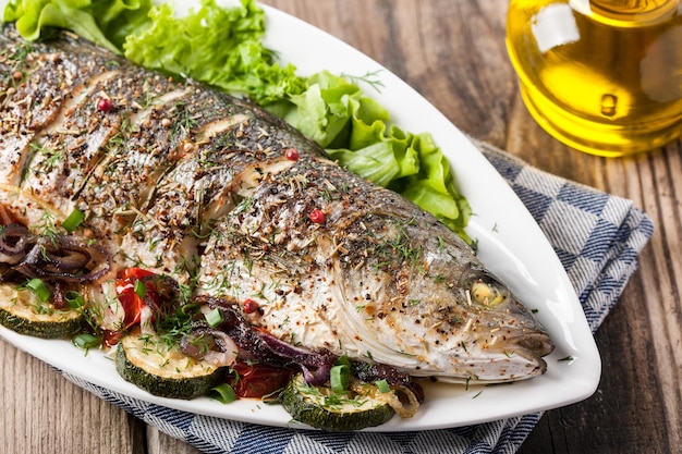 Dish of baked fish with vegetables