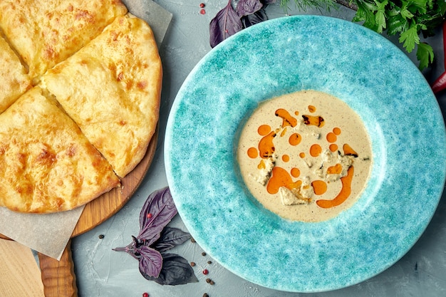 A dish of Georgian chicken fillet in nut sauce or Satsivi with khachapuri. Top view