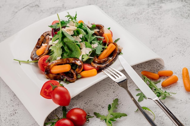 Dish of green salad with arugula vegetables and cheese parmesan