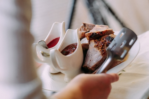 A dish of meat cut into slices with sauce