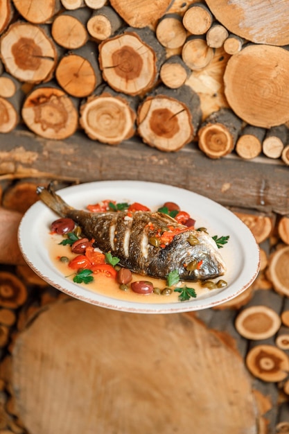 Dish plate with whole fried fish in a restaurant