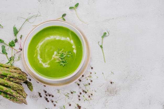 Dish of spinach cream soup and greens Close up