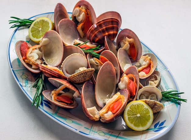 Dish of vivid fresh seafood with lemon and rosemary. 