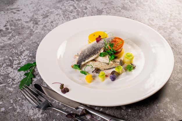 Dish of white fish with vegetables and herbs Healthy food