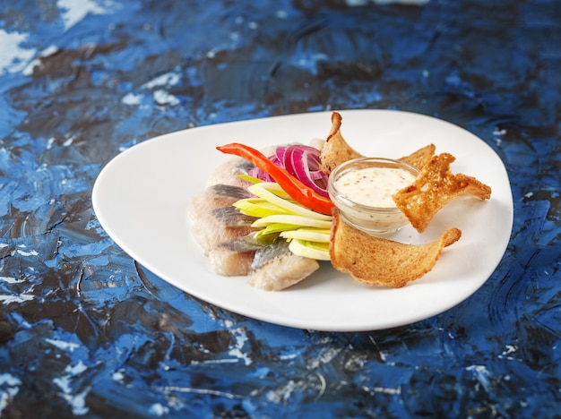 Dish with herring on a white plate.  