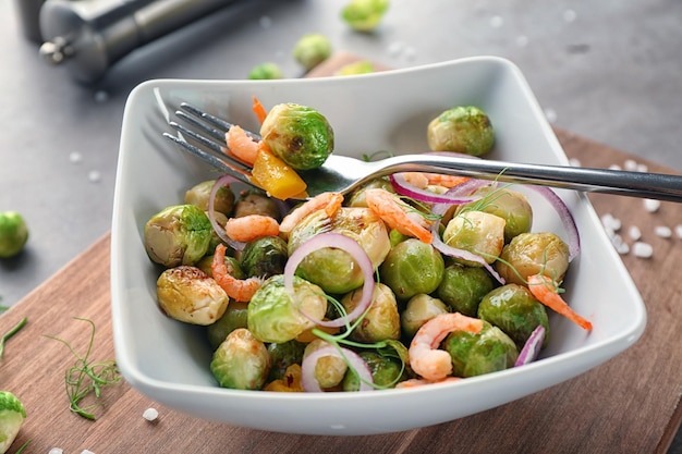 Dish with yummy brussel sprouts salad on table