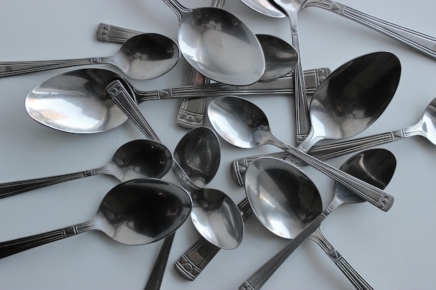 Disordered Spoons From Cutlery Set On Clean White Surface Stock Photo For Cutlery Background