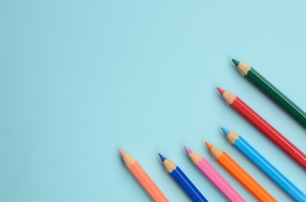 display of the empty space with colored pencils the concept of colored pencils on a blue background