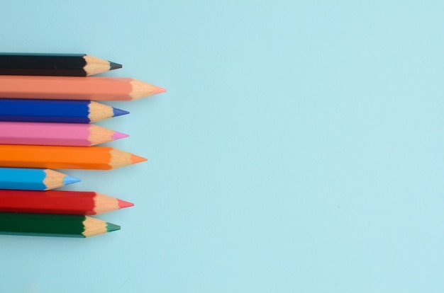 display of the empty space with colored pencils the concept of colored pencils on a blue background