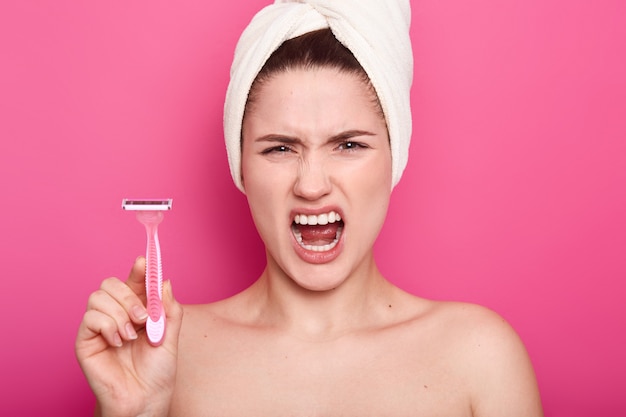 Displeased angry woman against of shaving