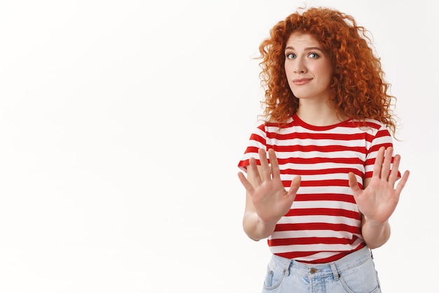 Displeased uncomfortable redhead attractive girlfriend pass raise hands stop rejection gesture asking enough hold willing end relationship refusing offer, white wall