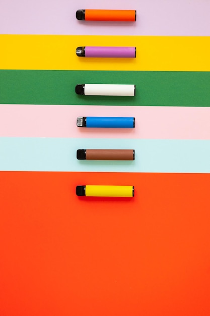 Disposable electronic cigarettes on color background