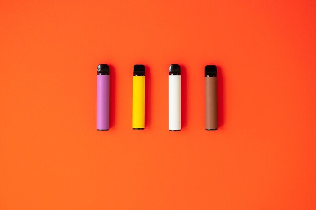 Photo disposable electronic cigarettes on red background