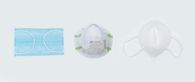 Disposable KN95 mask vs N95 mask vs surgical mask COVID19 prevention H1N1 H5N1 safety measures Isolated on black background