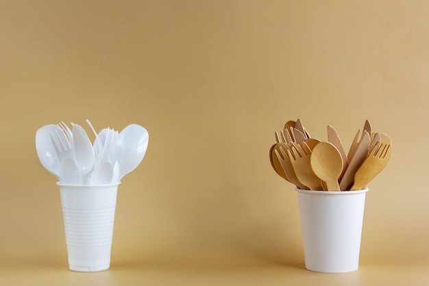 Disposable tableware made of plastic and natural wood and paper. Environmental protection concept.