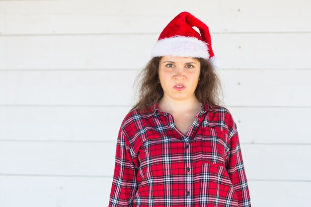 Dissatisfied angry santa in christmas hat on white with copy space