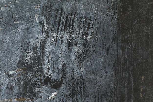 Distressed grunge textured dark gray antique concrete wall surface with spots for texture background