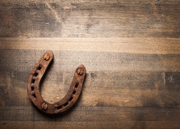 Distressed wood with a rusty horseshoe