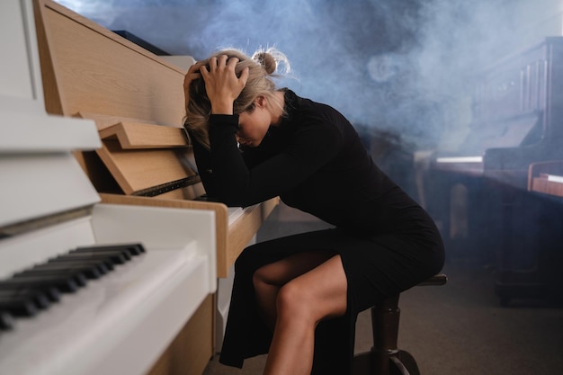 Distressed Young Musician in Black Dress Amidst Pianos A Portrait of Creative Burnout