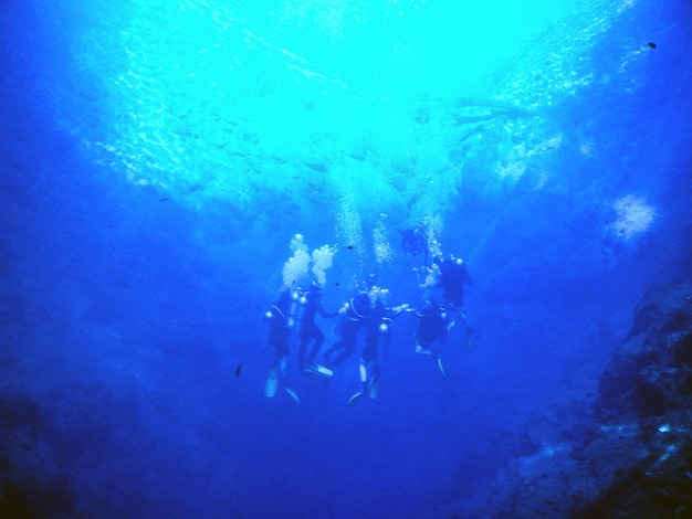 Divers in blue water lagoon