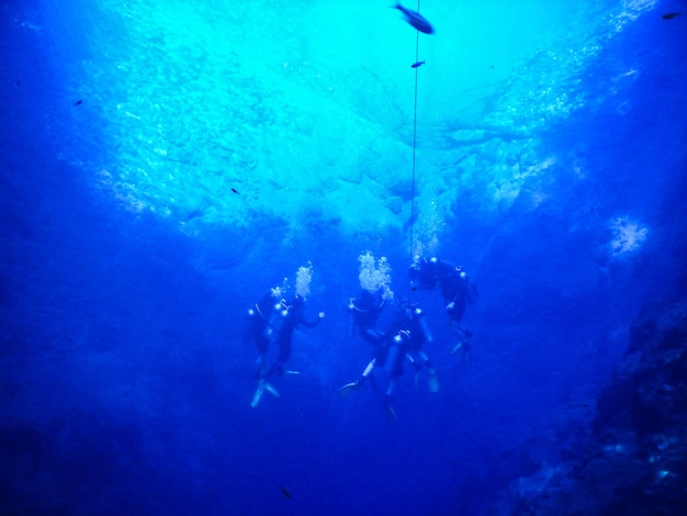 Divers in blue water lagoon