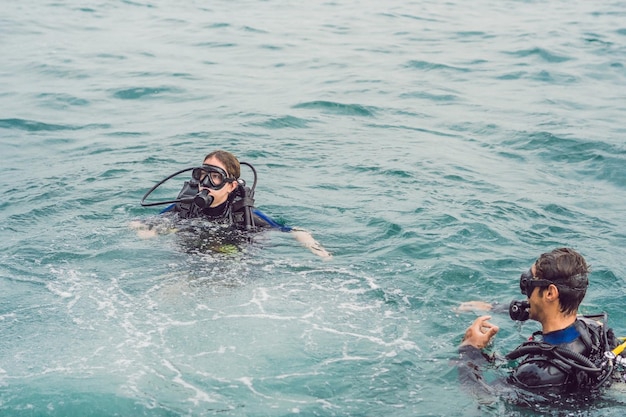 Divers on the surface of water ready to dive