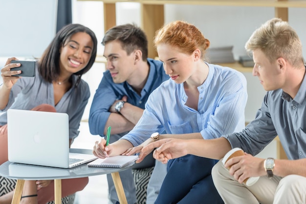 Diverse business team working on laptop in modern office