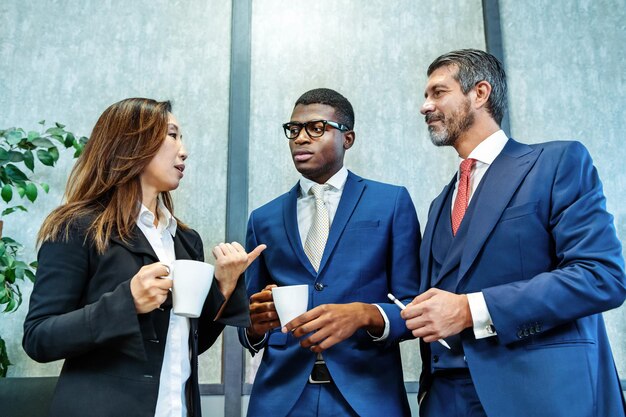 Diverse businesspeople talking during break