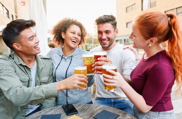 Diverse cheerful friends cheering with beer