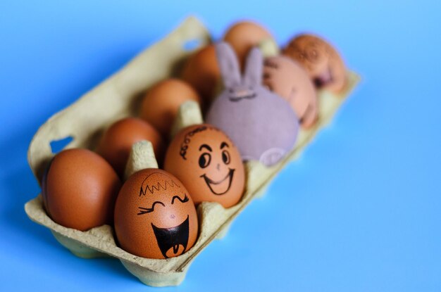 Diverse chicken eggs with doodle faces wearing medical masks on yellow background. Corona virus