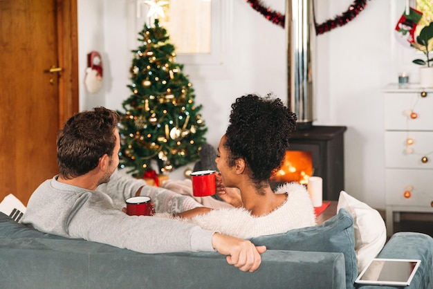 Diverse couple having cups of tea