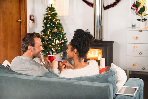 Diverse couple having cups of tea