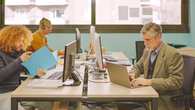 Diverse coworkers working in a shared table in a coworking