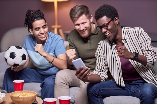 Diverse group of friends watching sports match online