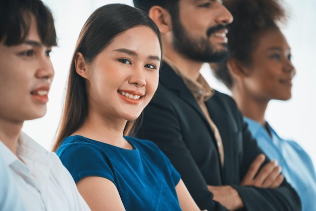 Diverse group of professional business people stand in line with cross arm gesture in modern corporate office Happy and smiling multiracial office worker team bond and succeed together Concord