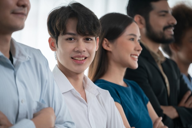 Diverse group of professional business people stand in line with cross arm gesture in modern corporate office Happy and smiling multiracial office worker team bond and succeed together Concord