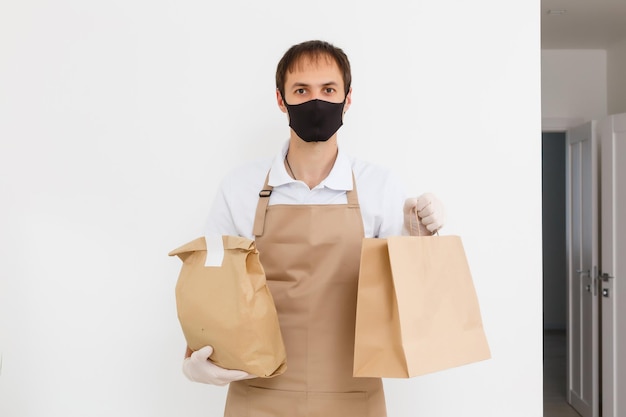 Diverse of paper containers for takeaway food. Delivery man is carrying