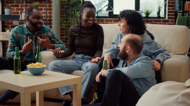 Diverse people having fun and talking about memories, having conversation about positivity and friendship. Laughing together at social gathering, chill pastime activity and bonding.