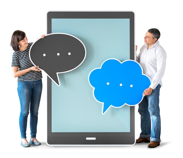 Diverse people holding speech bubbles and tablet