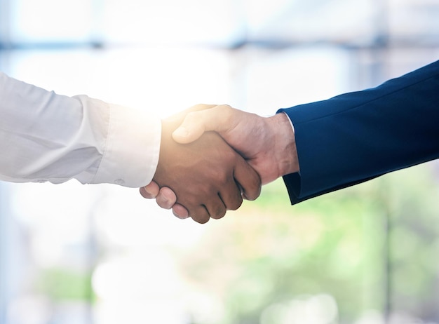 Diversity B2B partnership handshake and business people for collaboration company onboarding or teamwork innovation bokeh and lens flare Corporate men shaking hand in deal solidarity or thank you