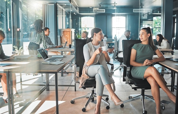 Diversity businesswomen and open plan office with a group of executive corporate colleagues and coworkers Talking team sharing ideas and innovation strategy in a modern workplace for collaboration