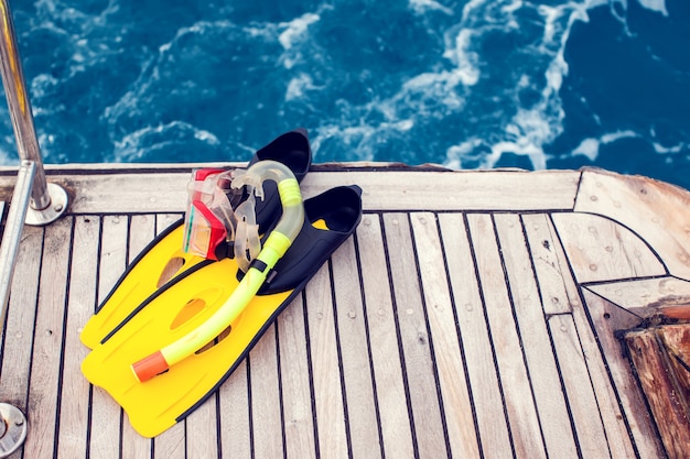 Diving mask and flippers lelft on boat