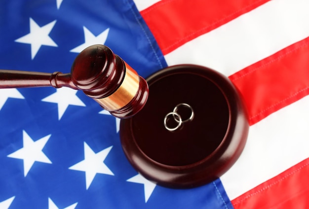 Divorce decree and wooden gavel on american flag background