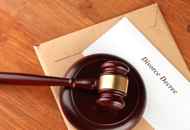 Divorce decree and wooden gavel on wooden background