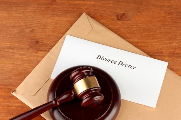 Divorce decree and wooden gavel on wooden background