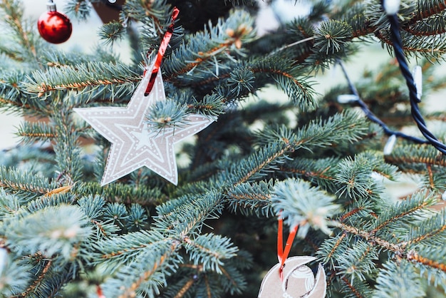 DIY cardboard paper Christmas star decorations on Christmas tree