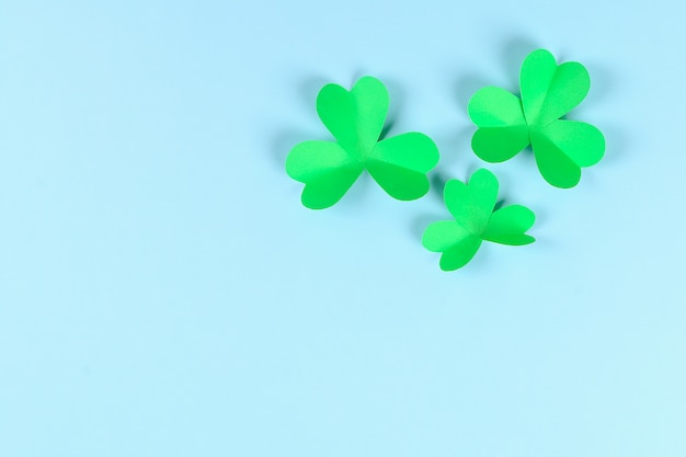 DIY green clover St. Patricks Day on blue background.