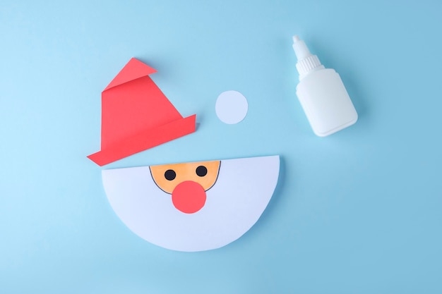 DIY and kid's creativity. Step by step instruction: how to make Santa claus from paper. Step3 draw Santa's face. Children's Christmas and New year craft