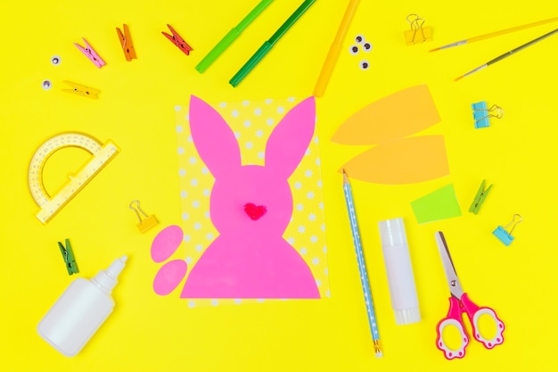 DIY and kids creativity. Step by step instruction: Create an Easter card with bunny and carrot. Childrens handmade Easter craft. Top view Step 1